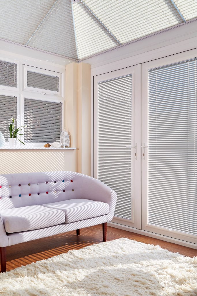 Grey Perfect Fit Venetian blinds on white conservatory window frames